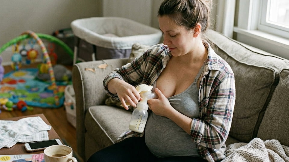 Mum using a manual breast pump