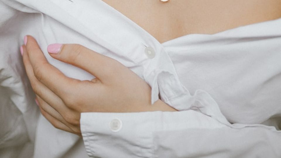 Woman holding chest